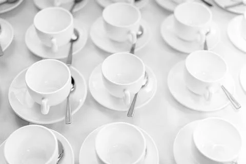 Many rows of white ceramic coffee or tea cups. Lines of coffee cups Stock Photos