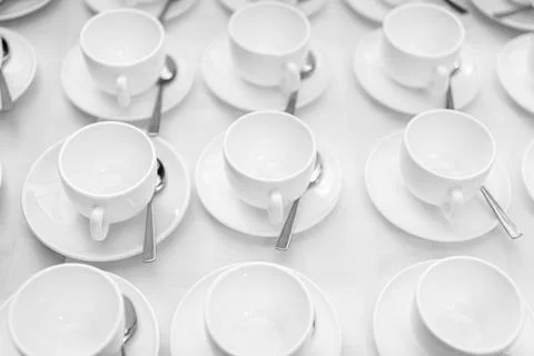 Many rows of white ceramic coffee or tea cups. Lines of coffee cups Stock Photos