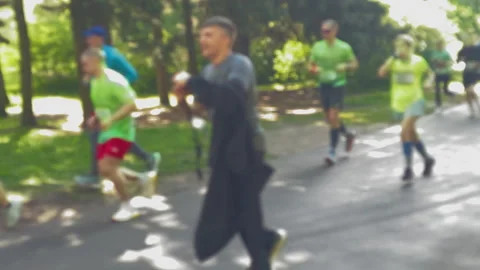 Many runners running marathon in green summer park, training Stockbeeldmateriaal 314459006
