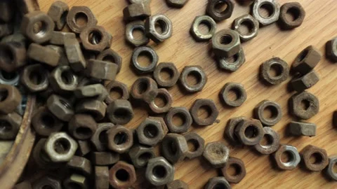 Many rusty elements. Old rusty nut. Dirty metal nuts are scattered on the table Stock Footage 232538215