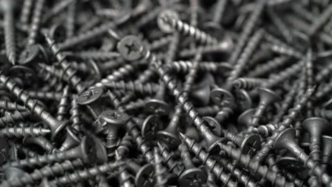 Many self tapping screws rotate motion background Stock Footage 93262256
