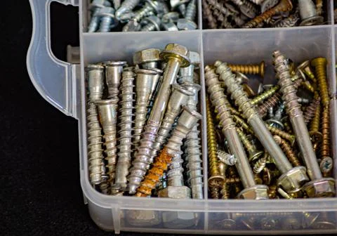 Many self-tapping screws stacked in sections in boxes Fotos de archivo