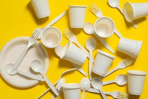 Many sets of biodegradable disposable tableware on a  yellow  background Stock-Fotos