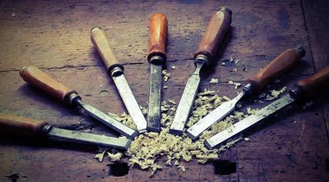 Many sharp chisels with sawdust and vintage effect Stock Photos