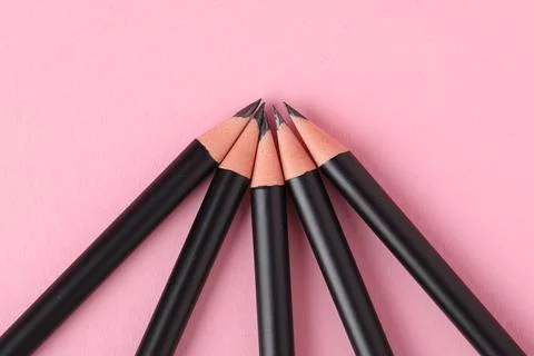 Many sharp graphite pencil on pink background, flat lay 写真素材