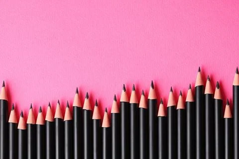 Many sharp graphite pencil on pink background, flat lay. Space for text 스톡 사진