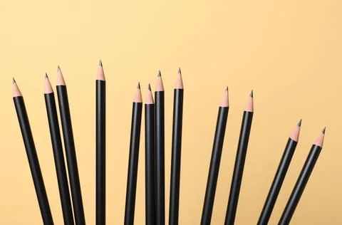 Many sharp graphite pencils on beige background, closeup Stock Photos