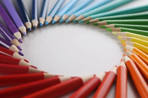 Many sharp multicolored sharp pencils lying in shape of circle closeup Stock Photos