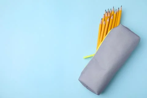 Many sharp pencils in pencil case on light blue background, top view. Space.. 스톡 사진