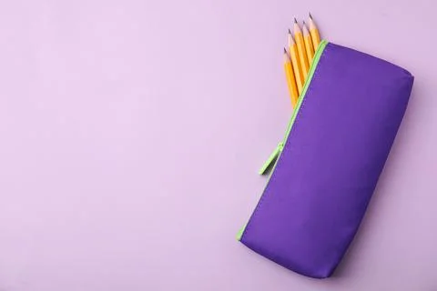 Many sharp pencils in pencil case on pink background, top view. Space for tex 写真素材