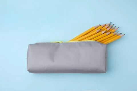 Many sharp pencils in pencil case on light blue background, top view Stock Photos