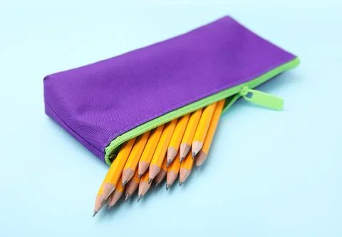 Many sharp pencils in pencil case on light blue background 스톡 사진