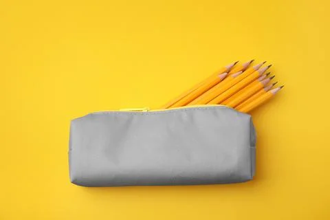 Many sharp pencils in pencil case on yellow background, top view Stock Photos