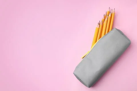 Many sharp pencils in pencil case on pink background, top view. Space for tex 스톡 사진