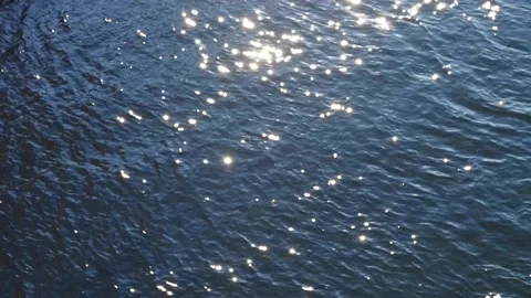 Many shiny reflections of the sun in the water surface. texture of waves clos Stock Footage 167339079