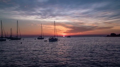 Many siling boats are standing on the sea and the sun is going down Stock Footage 81396302