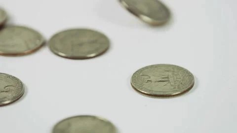 Many silver quarters falling and spinning on white background Stock Footage 329596089