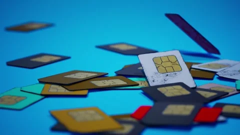 Many sim cards for mobile phone falling down on blue background. Drop on the Stock Footage 257928393