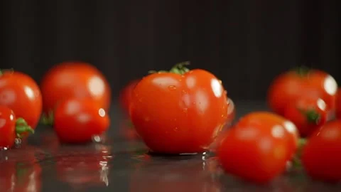 Many small cherry tomatoes roll into the frame. Stock Footage 274192965