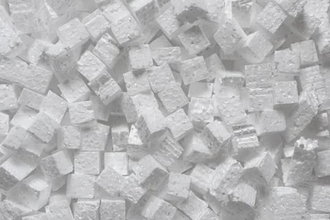 Many small cubes of white polystyrene, top view. Packaging material that creates Fotos Stock