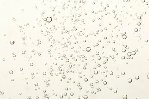 Many small fizz bubbles flows toward the surface Stock Photos