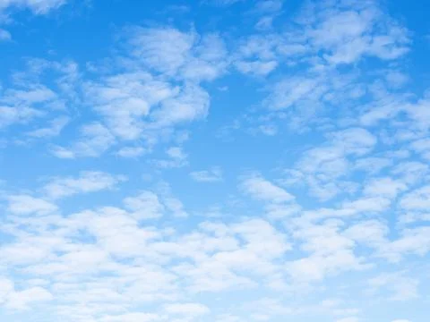 Many small light clouds in blue sky on autumn day Stock Photos