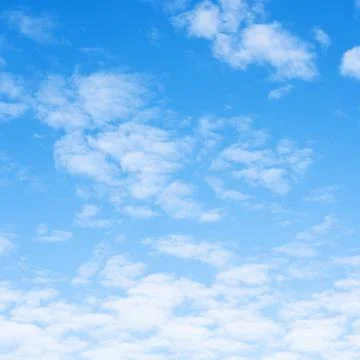 Many small light fluffy clouds in blue sky Stock Photos