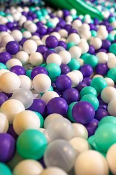 Many small multi-colored plastic balls in the pool desk Stock Photos