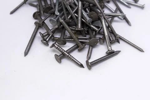 Many small nails on a white background Stock Photos