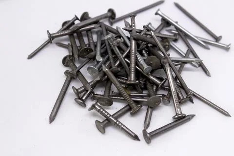 Many small nails on a white background Stock Photos