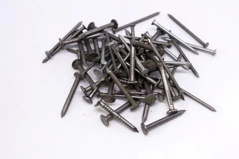 Many small nails on a white background Stock Photos