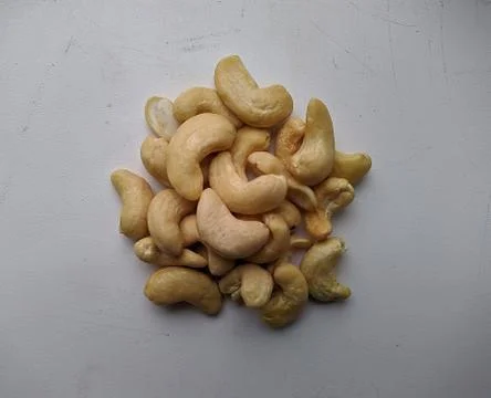 Many small nuts on a white background closeup photo Stock Photos