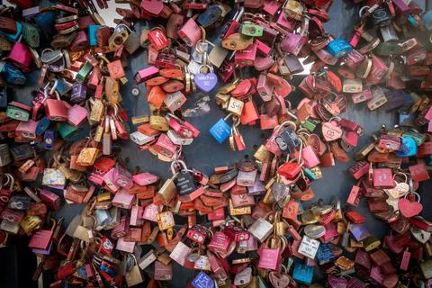 Many small padlocks with names of couples hang as a symbol of love Stock Photos
