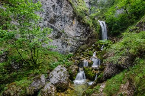 Many small steps at the waterfall in the mountains Stock Photos