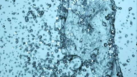 Many small water droplets falling and splashing against ligh Stock Footage 326031252