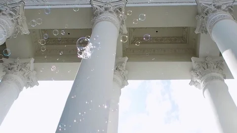 Many soap bubbles fly on the background of the classical portico with columns, Видео 121833711