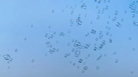 Many soap bubbles fly over clean blue sky on background Stock Footage 206732450