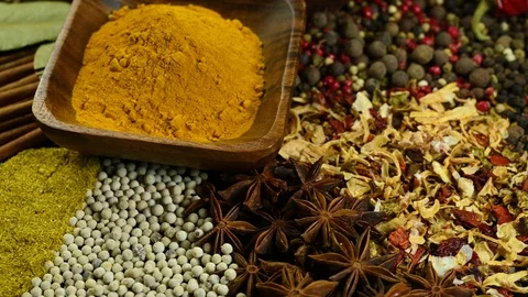 Many spices sprinkled on table and spin Stock Footage 121115660