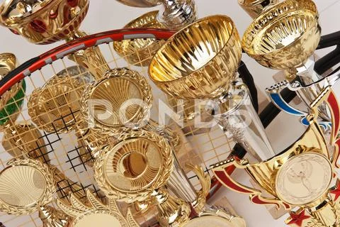 Many sports awards and tennis racket Stock Photos