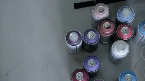 Many spray cans stand on the floor close up. Video stock 77694662