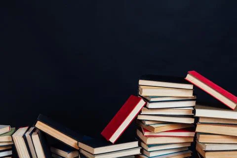Many stacks of educational books for learning preparation for college exams on a Stock Photos