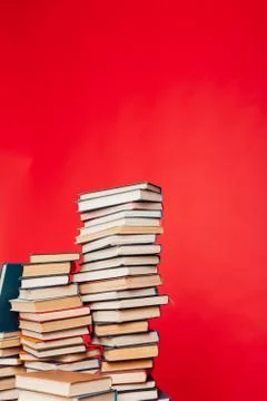 Many stacks of educational books to study in the college library on a red 스톡 사진