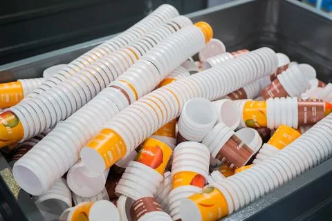 Many stacks of empty orange and brown plastic cups at warehouse Stockfoto's