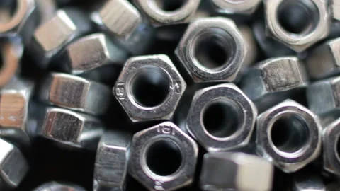 Many stainless hex nuts rotating close-up. Metal industry concept. Stock Footage 229956699