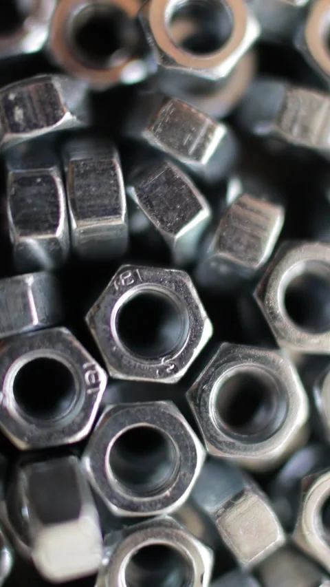 Many stainless hex nuts rotating close-up. Metal industry concept. Stock Footage 274208785