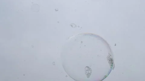 Many Sticky Multicolored Soap Bubbles on the Surface of Wet Transparent Glass Stock Footage 253778901
