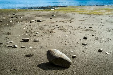 Many stones with different sizes on the beach in sunshine Stock Photos