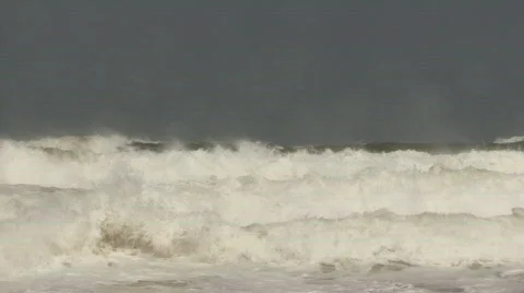Many stormy waves rolling into sandy beach Stock Footage 460362