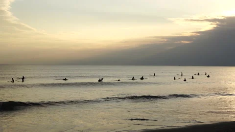 Many sufers in the Evening Stock Footage 138688612