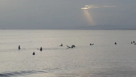 Many sufers in the Evening Stock Footage 138783360